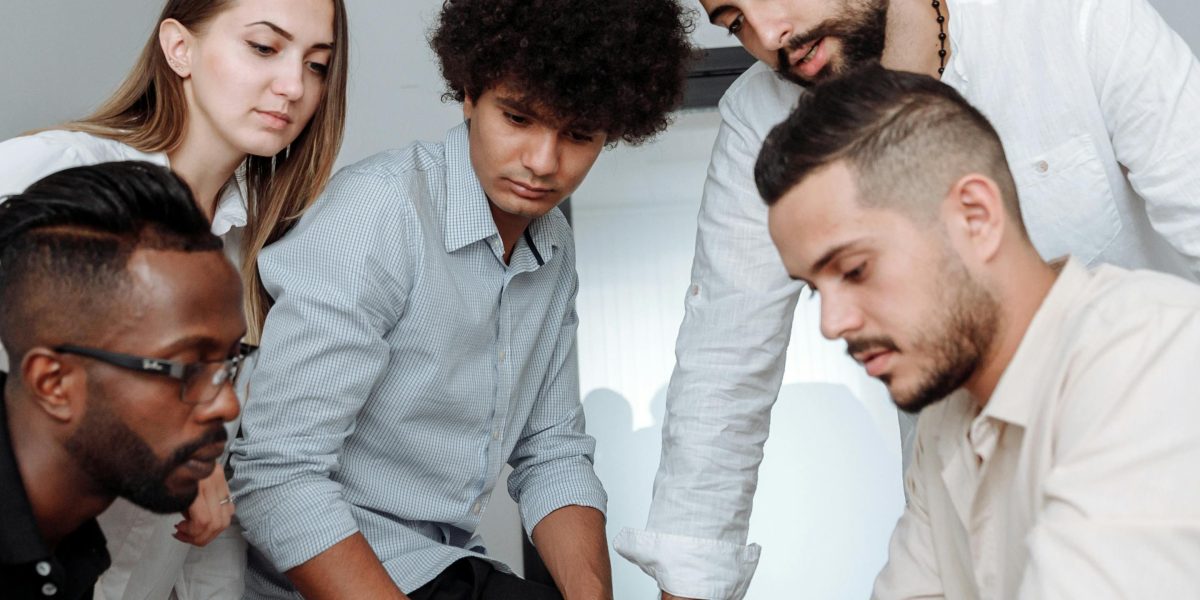 A team collaborating to identify and resolve a technical issue, ensuring continuous website operation.