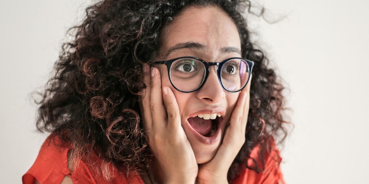 A person reacting with surprise or frustration upon reviewing an unexpectedly high or complicated bill.