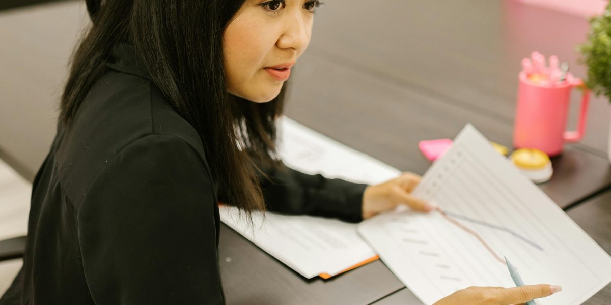 An entrepreneur reviewing growth charts, symbolizing business expansion and scaling.