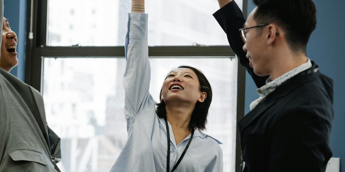 A team of professionals celebrating a project milestone or business growth, depicting the positive outcome of a successful online presence.