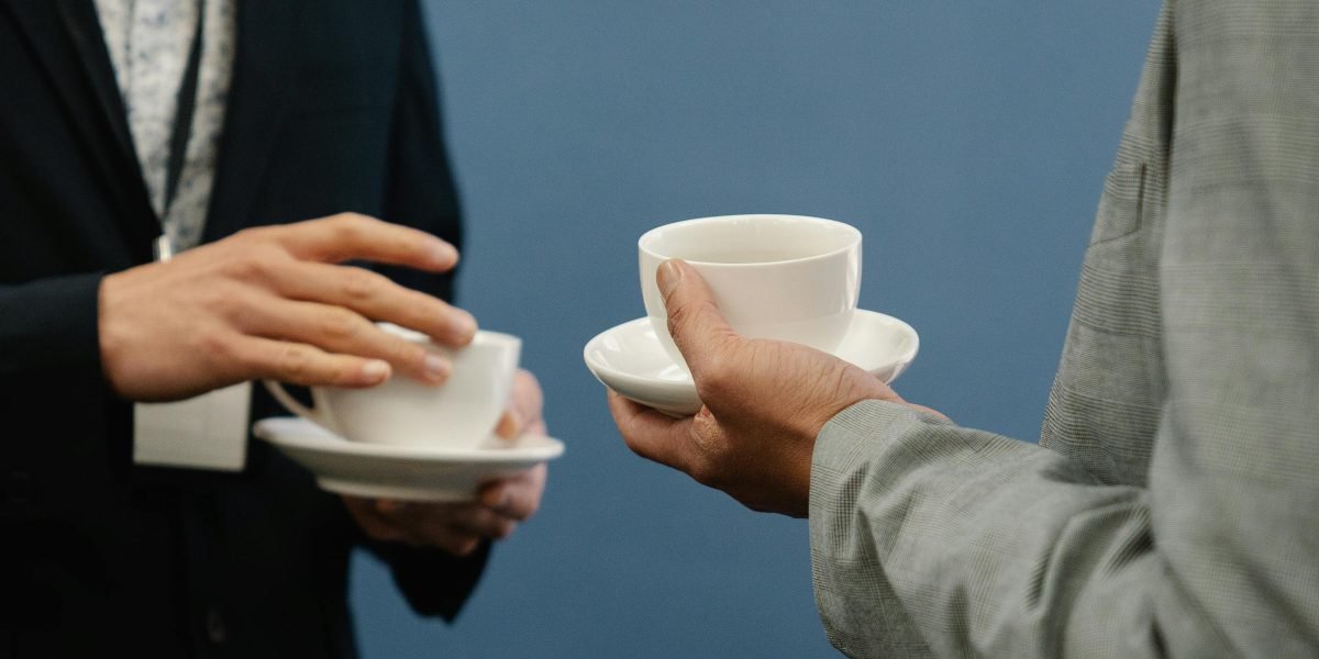 A business owner meeting with a client, focusing on the human aspect of managing customer relationships.