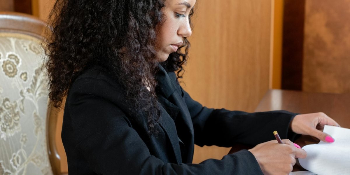 A person focused on reviewing documents, representing the careful consideration needed to choose a hosting provider.