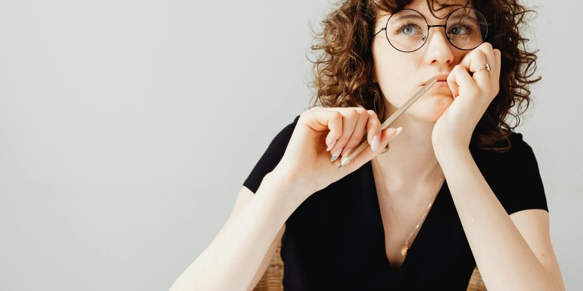 A person deep in thought, perhaps contemplating a new website or online business venture.