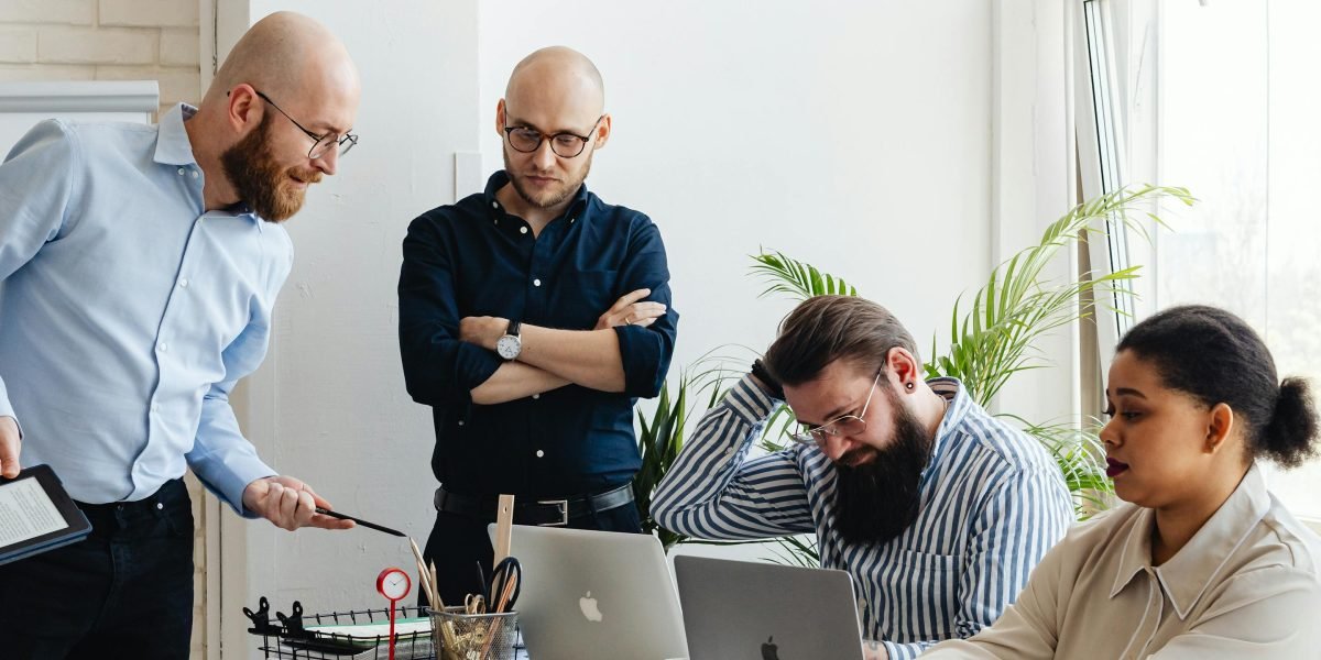 A small team collaborating in an office setting, focusing on business growth and strategy.