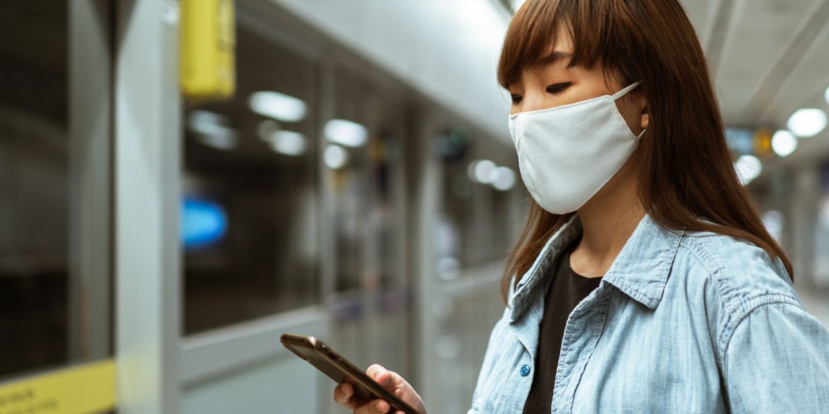 A person using their phone while out and about, representing the mobile app's convenience for on-the-go practice.
