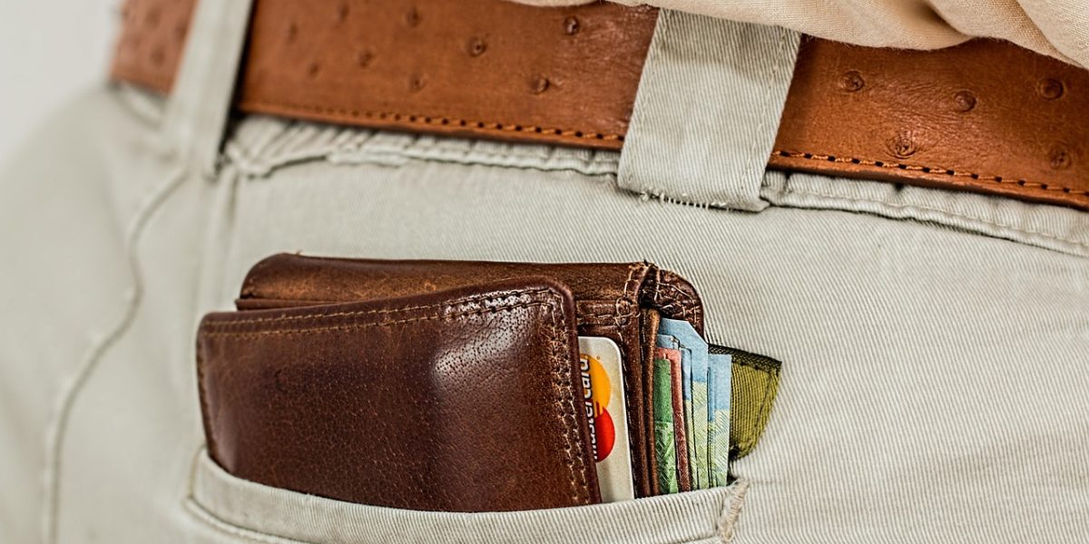 A person confidently reviewing financial documents or a budget, representing smart money-saving strategies.