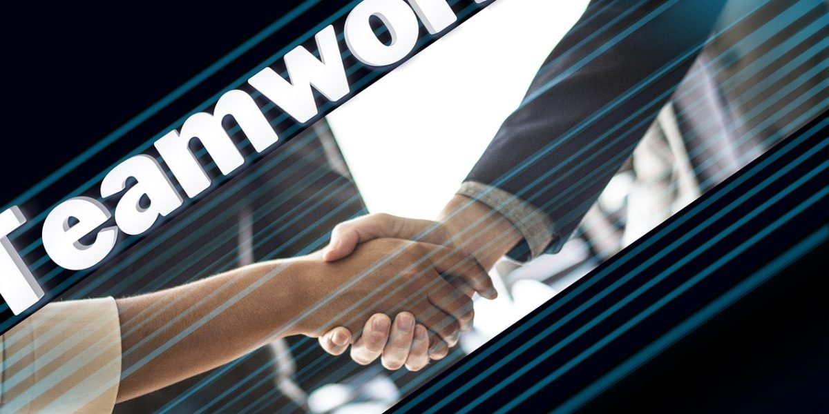 Two business professionals confidently shaking hands, symbolizing successful partnerships and recognition.