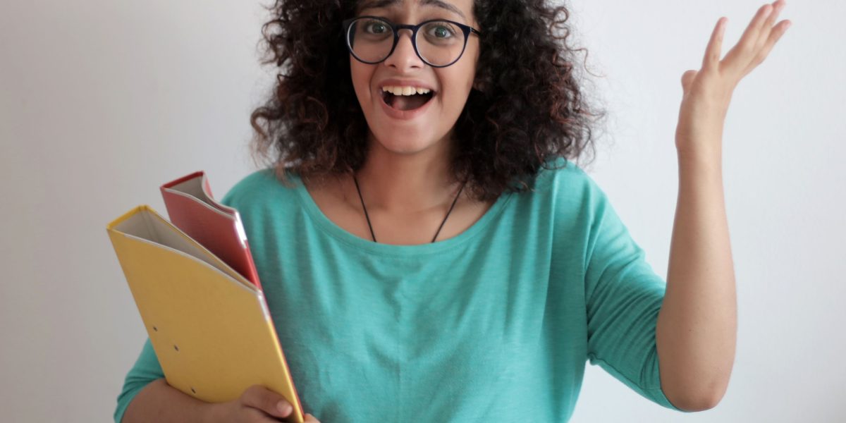 A person looks perplexed while examining financial documents, symbolizing the common frustration business owners face with unclear pricing structures.