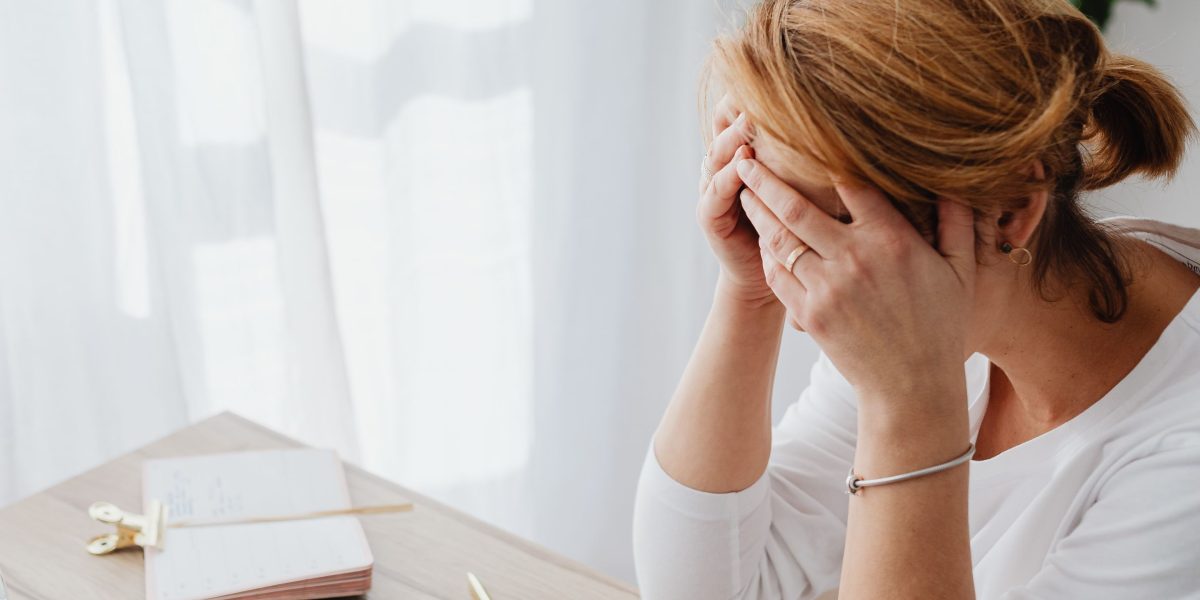 A small business owner looks surprised and concerned while reviewing a domain renewal bill.