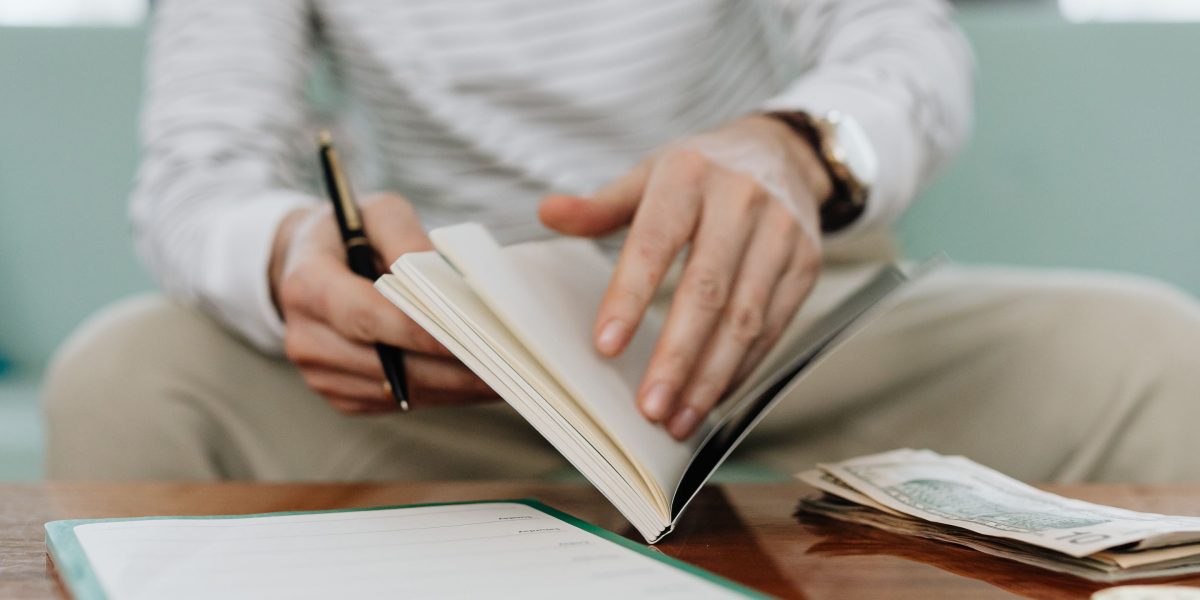 A person intently reviewing financial documents, symbolizing the importance of budgeting for business expenses.