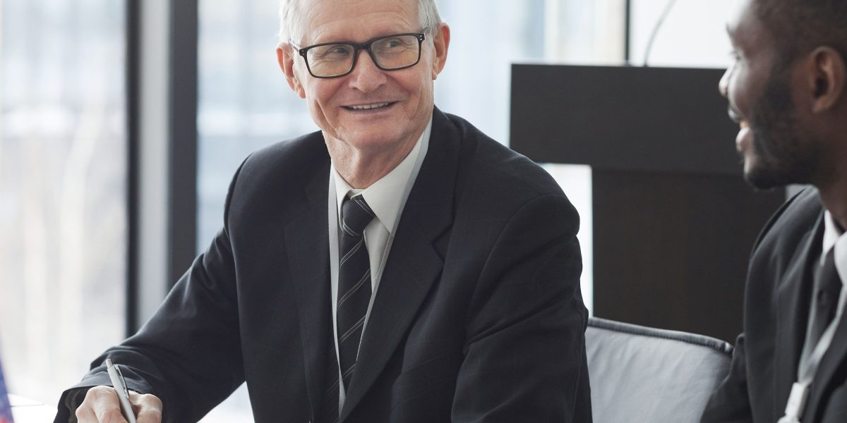 A business professional confidently engaged in a discussion or negotiation, aiming to secure better terms.