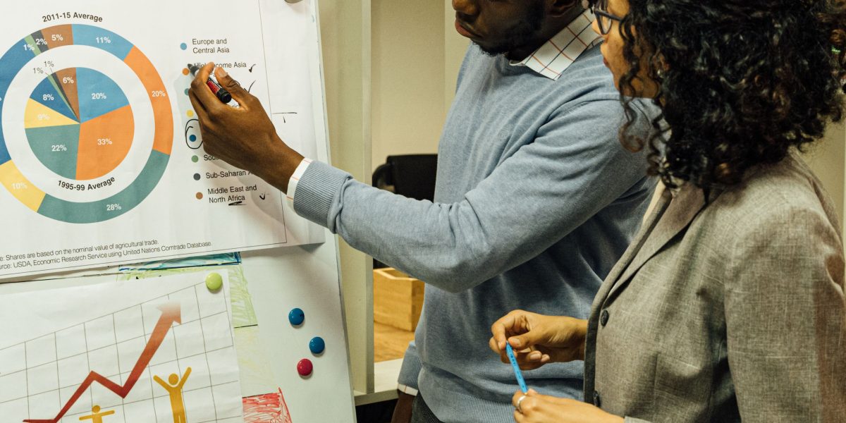 A team discussing business growth in a meeting, symbolizing the scalability needs of a growing online business.
