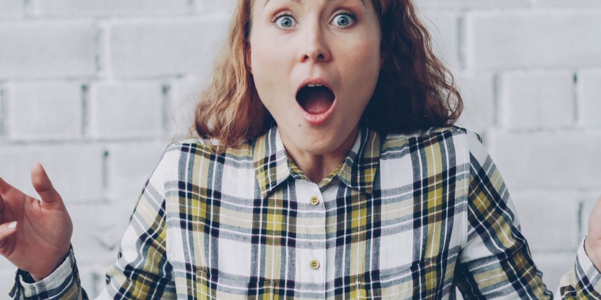 A person looking surprised or dismayed by unexpected charges on a bill, representing hidden fees.