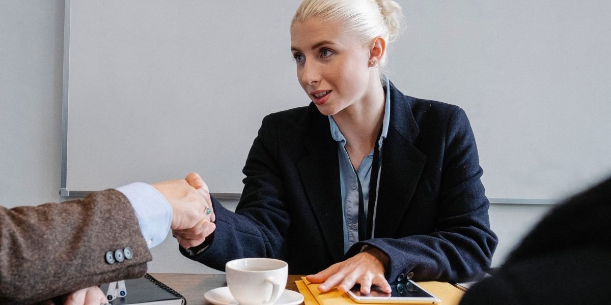 Business professionals engaged in a discussion, likely negotiating terms for a deal.
