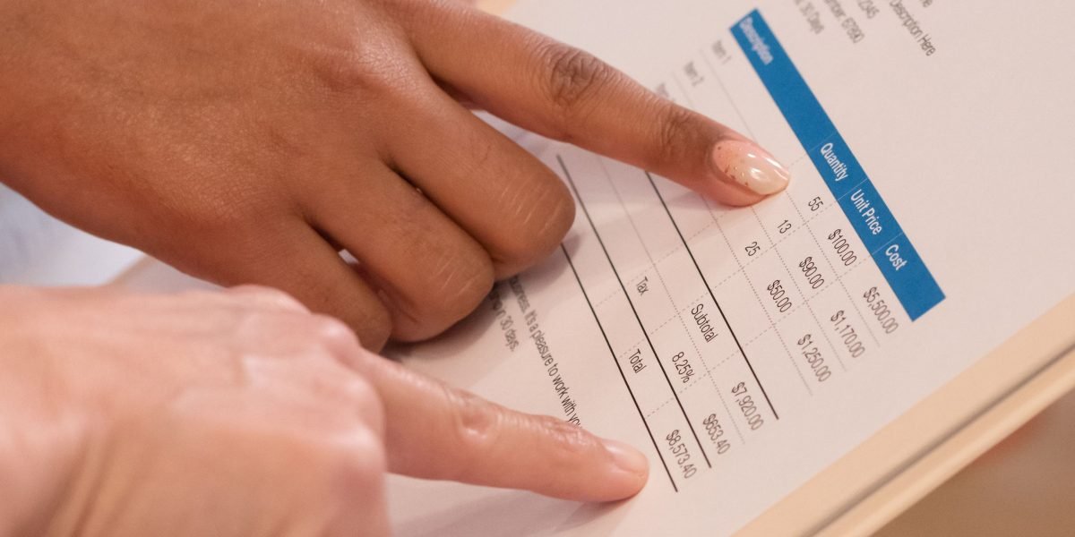 A user focused on a screen, meticulously analyzing different web hosting plans and their cost structures, particularly renewal rates.