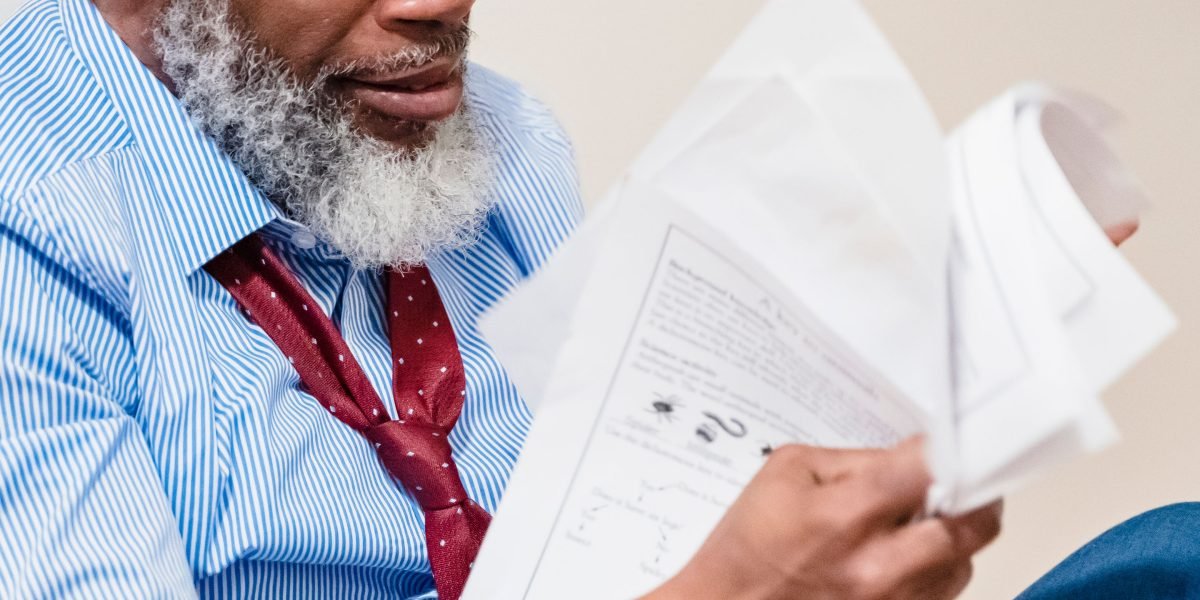 A business owner thoughtfully reviews documents, considering unexpected or hidden costs for their online business.