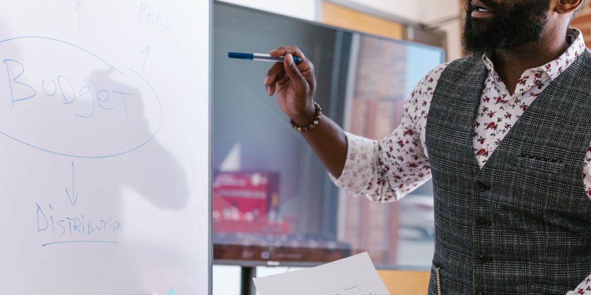 An entrepreneur thoughtfully planning their online business strategy, considering important initial steps like domain names and costs.
