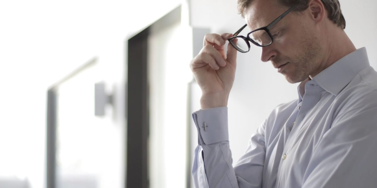 A business owner thoughtfully considering important decisions for their online presence and future growth.