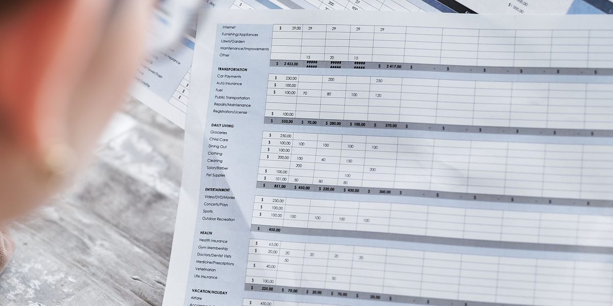 A person carefully reviewing financial documents or invoices, ensuring clarity and understanding of costs.