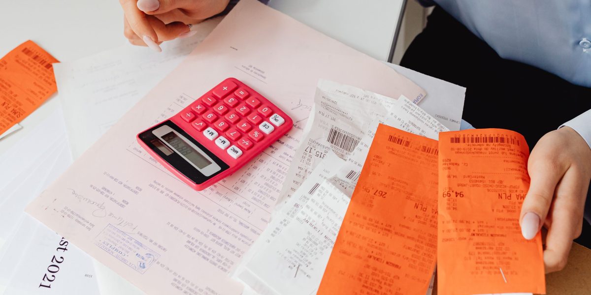 A person looks confused and stressed while examining a bill, symbolizing the common billing surprises small businesses face.
