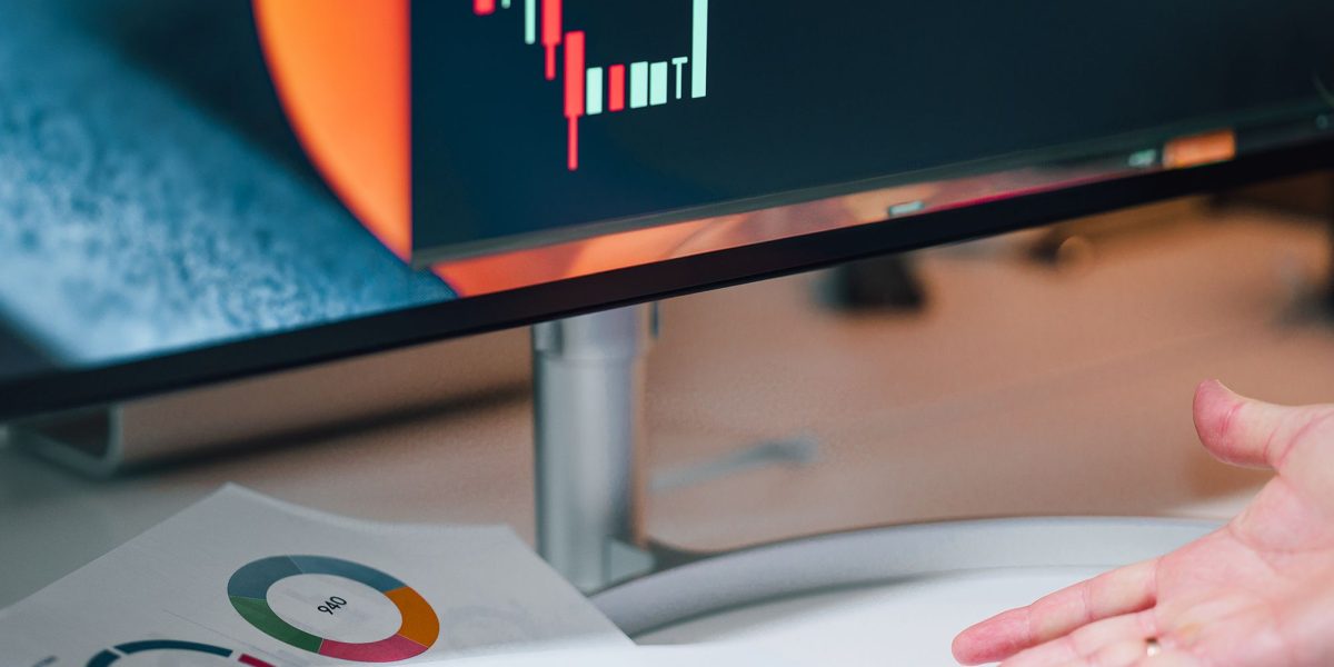 Professionals collaborate, reviewing charts and data to compare different web hosting pricing models and find the best fit.