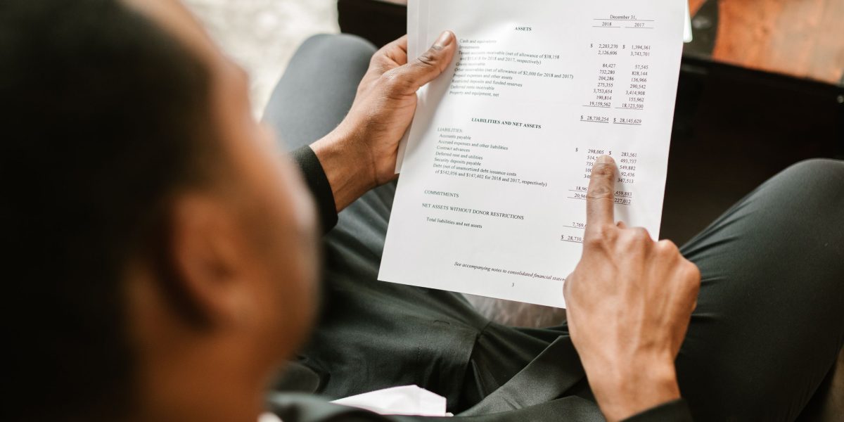 An entrepreneur carefully reviews financial projections and cloud hosting estimates.