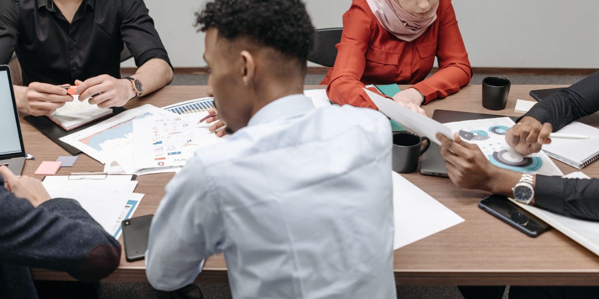 A team collaborating around a whiteboard, strategizing their website's future and determining the optimal cPanel license to support their growth.