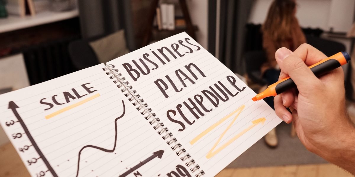 A business owner thoughtfully plans their online presence and budget for future success.