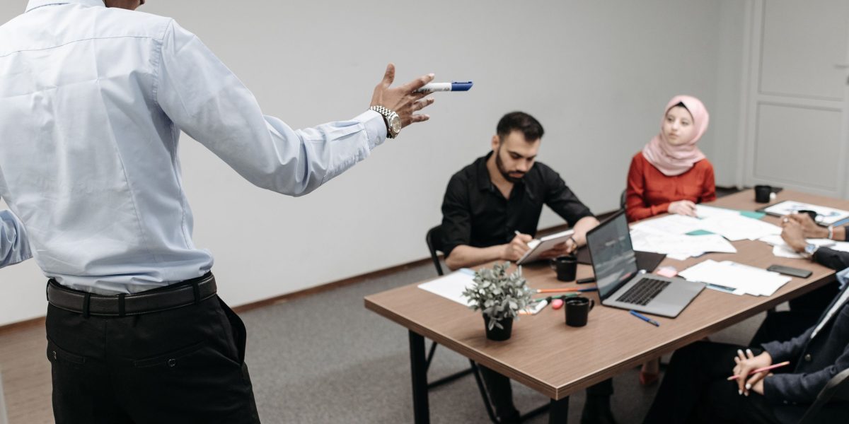 A team collaborating in an office setting, discussing strategy and long-term value beyond immediate costs.