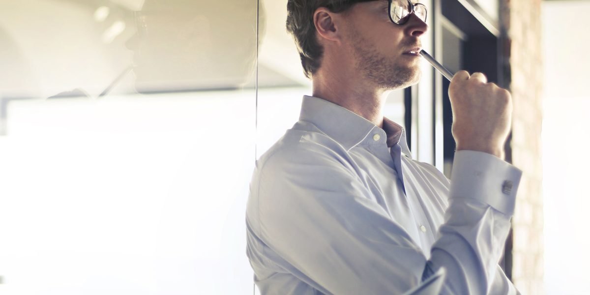 A business owner contemplating strategic decisions for online presence, reflecting the complexities of choosing web hosting.