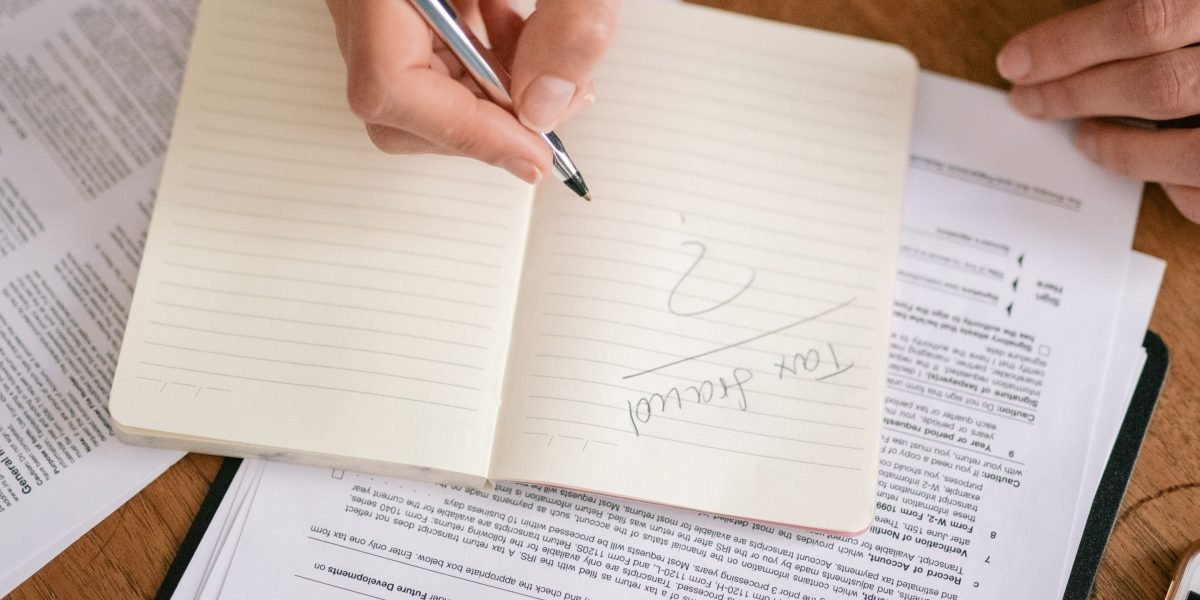 A person carefully reviewing financial documents, representing the importance of cost predictability in web hosting.
