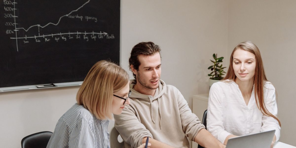 A team collaborates around a whiteboard, actively planning for future business growth and expansion.