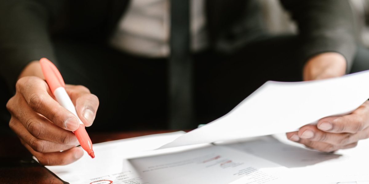 An entrepreneur meticulously reviewing a checklist for setting up and managing their business's web address.