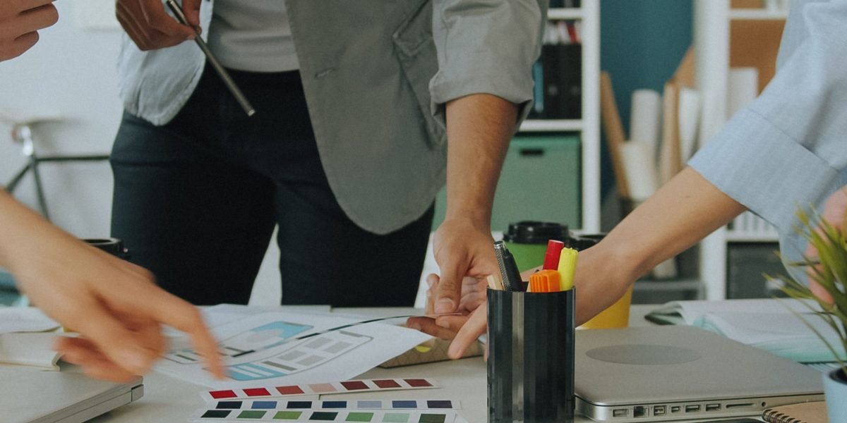 A small business team actively collaborating in a meeting, brainstorming ideas for their brand's online identity.