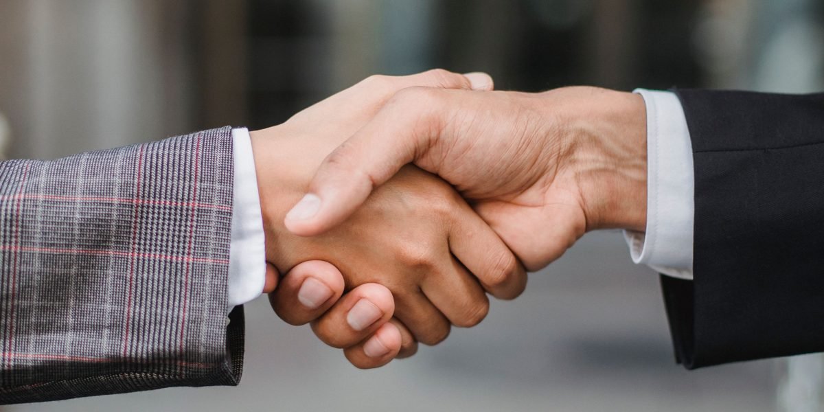Two professionals shaking hands, signifying a new partnership or successful business agreement.