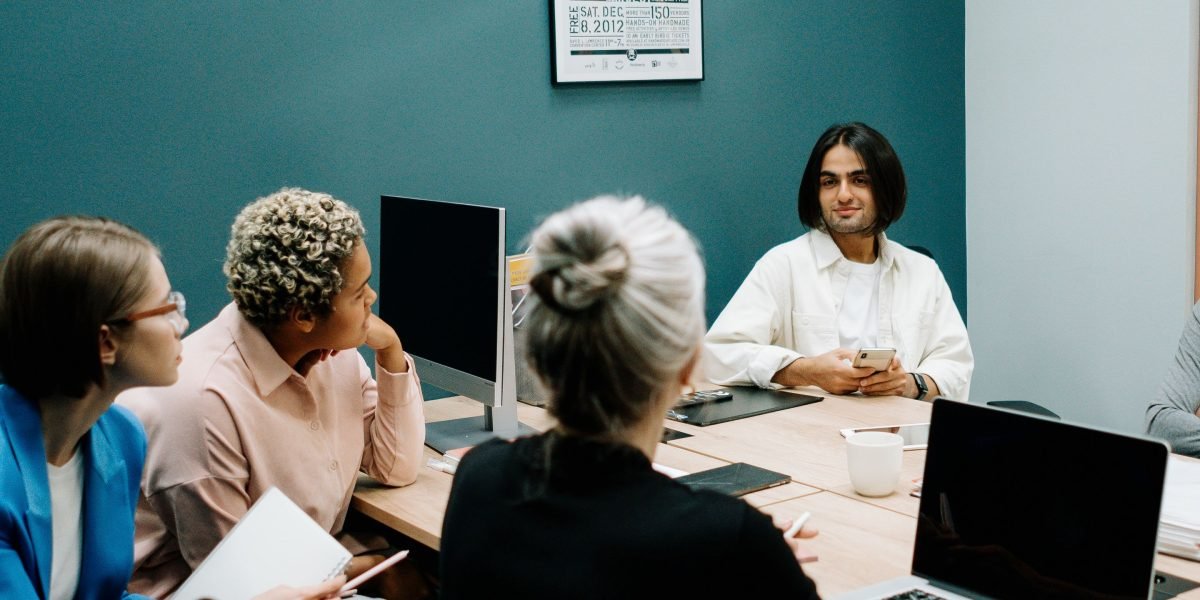A team in a modern office setting discussing important security measures and protections for their digital assets.
