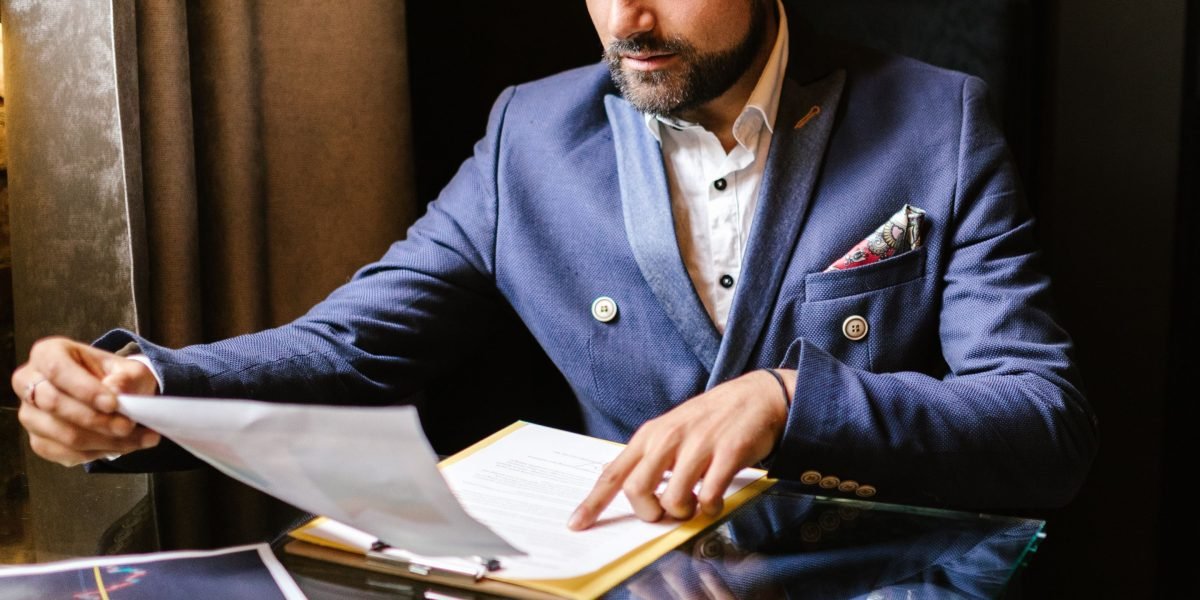 An entrepreneur carefully analyzing financial statements to understand the total cost of ownership for business services.